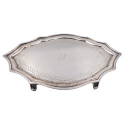 George III silver teapot stand, of shaped form with engraved foliate border and central initial, upon four bracket feet, hallmarked John Langlands I & John Robertson, Newcastle, no date letter present, W18.5cm, approximate weight 4.65 ozt (144.7 grams)
