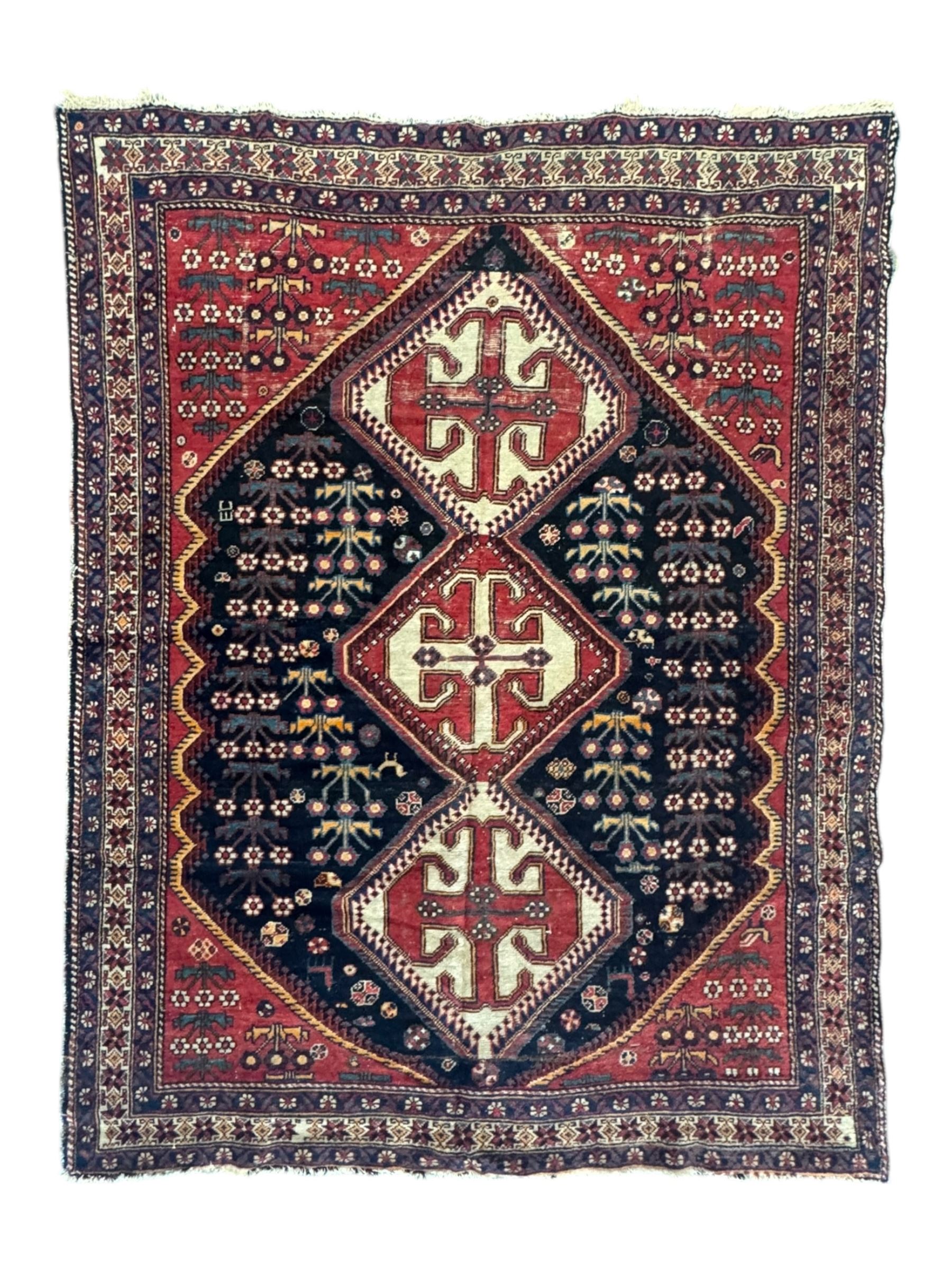 Persian Heriz wool rug, red and ivory field with floral medallion, geometric spandrels, and floral border (157cm x 107cm); Kurdish Shairwan wool rug, red and navy field with three medallions, geometric crosses and serrated border (200cm x 155cm); Persian Qashqai wool rug, golden-yellow field with boteh motifs and wide floral border (127cm x 82cm)