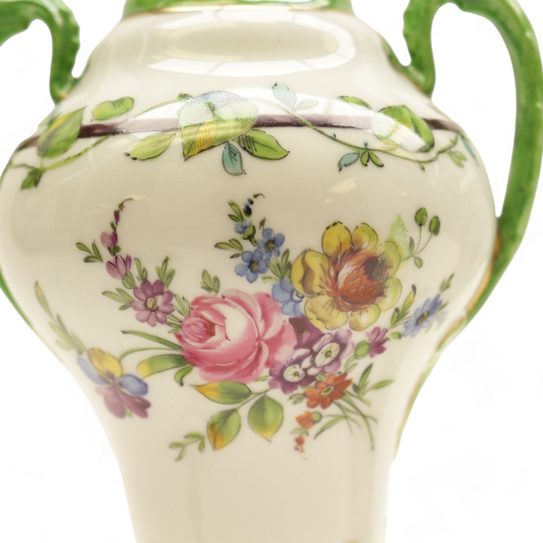 Pair of Dresden lidded vases with twin handles, decorated with flowering sprigs and a foliate boarder, H25cm