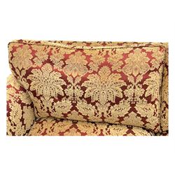 Duresta - pair of Grande three-seat sofas, traditional shaped with rolled arms and upholstered loose cushions, in red ground fabric with raised gold foliate pattern, on turned feet with brass castors 