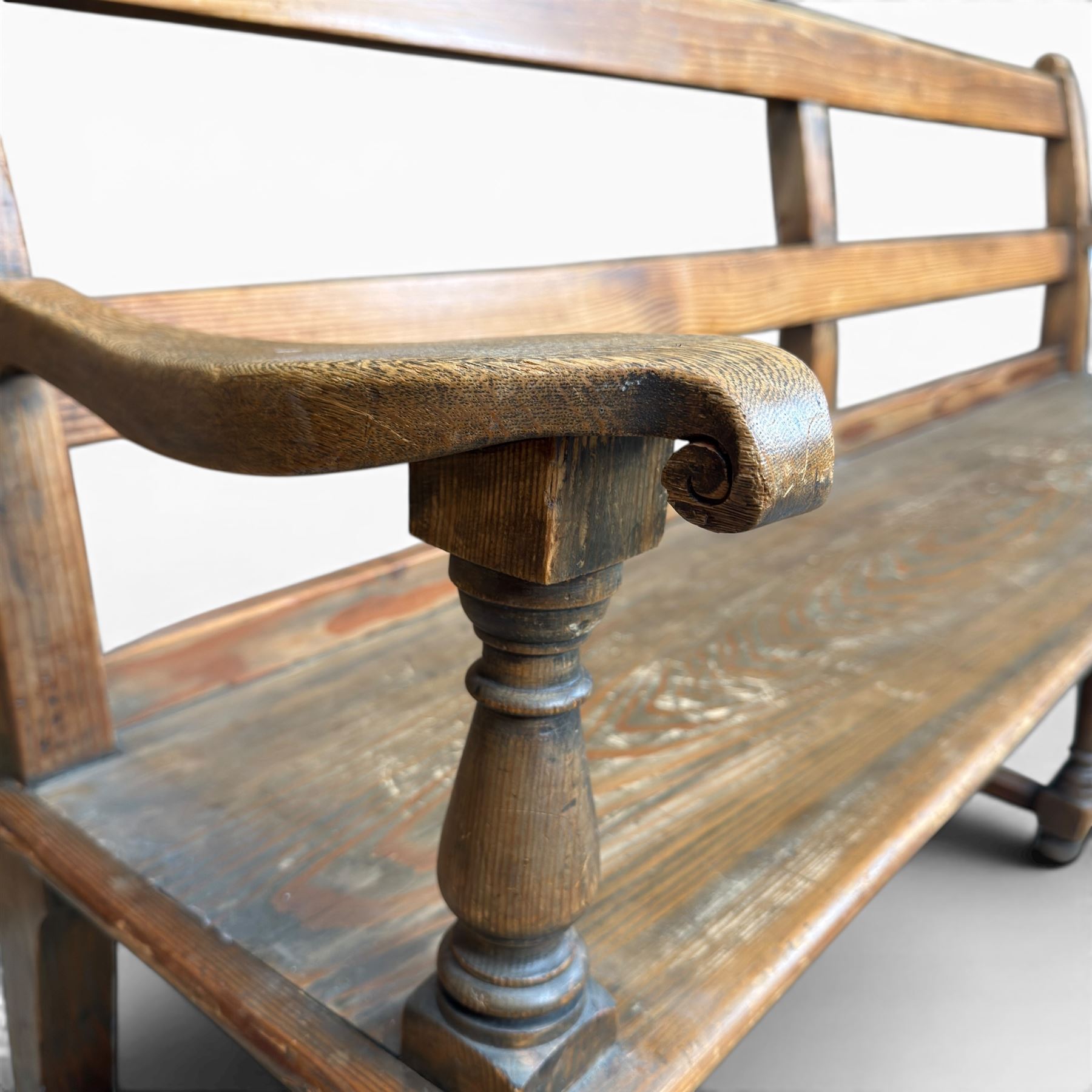 Early 20th century pine and oak bench seat, stained pine rail back frame with shaped oak arms