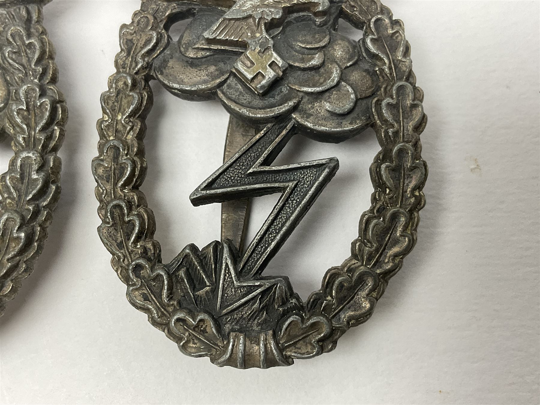 Two WW2 German Luftwaffe Ground Assault/Combat badges - one with flat pin and maker's mark M.u.K.; the other unmarked with round pin (2)