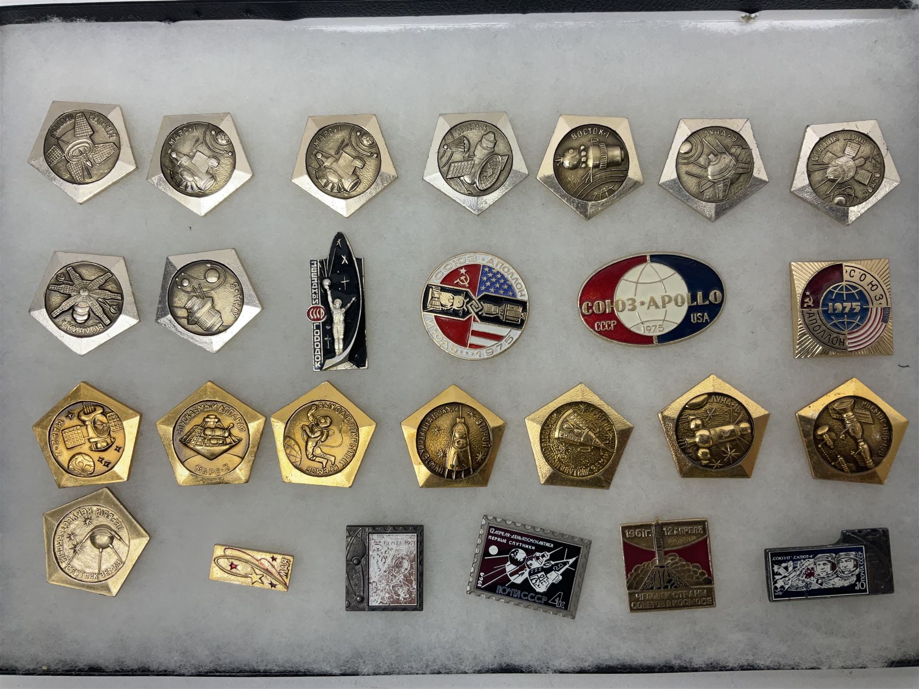 Twenty-six Russian Soviet Space badges 1960s/70s; in small display case