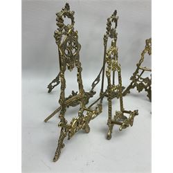 Nine ornate cast brass easel stands of various sizes, H24cm