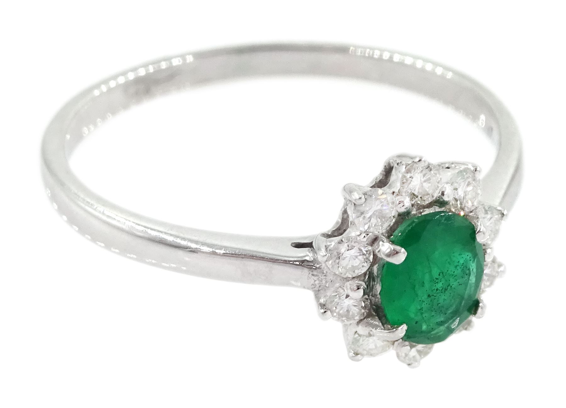 18ct white gold oval cut emerald and round brilliant cut diamond cluster ring, stamped 750