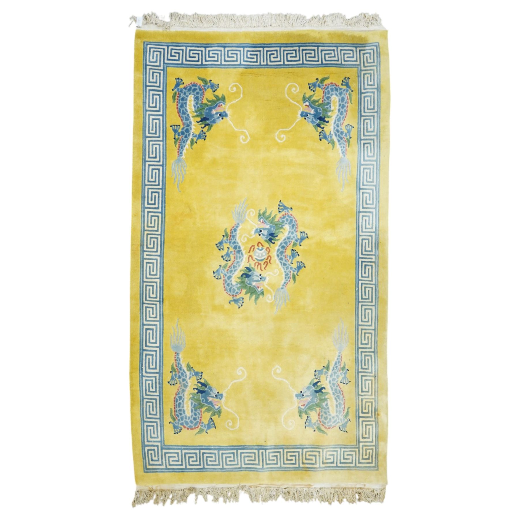 Modern Chinese hand-knotted wool pile carpet, golden field decorated with conforming dragons amidst stylized cloud scrolls enclosed by a Greek gey meander border, with cotton fringe ends 