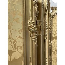 Late 19th/early 20th century French Rococo style gilt wood and gesso dressing screen, four double hinged panels, each with shaped cresting rail over shell and floral frieze, moulded frame with flower head and scroll decoration, acanthus leaf cabriole supports with castors, upholstered in gold Damask fabric