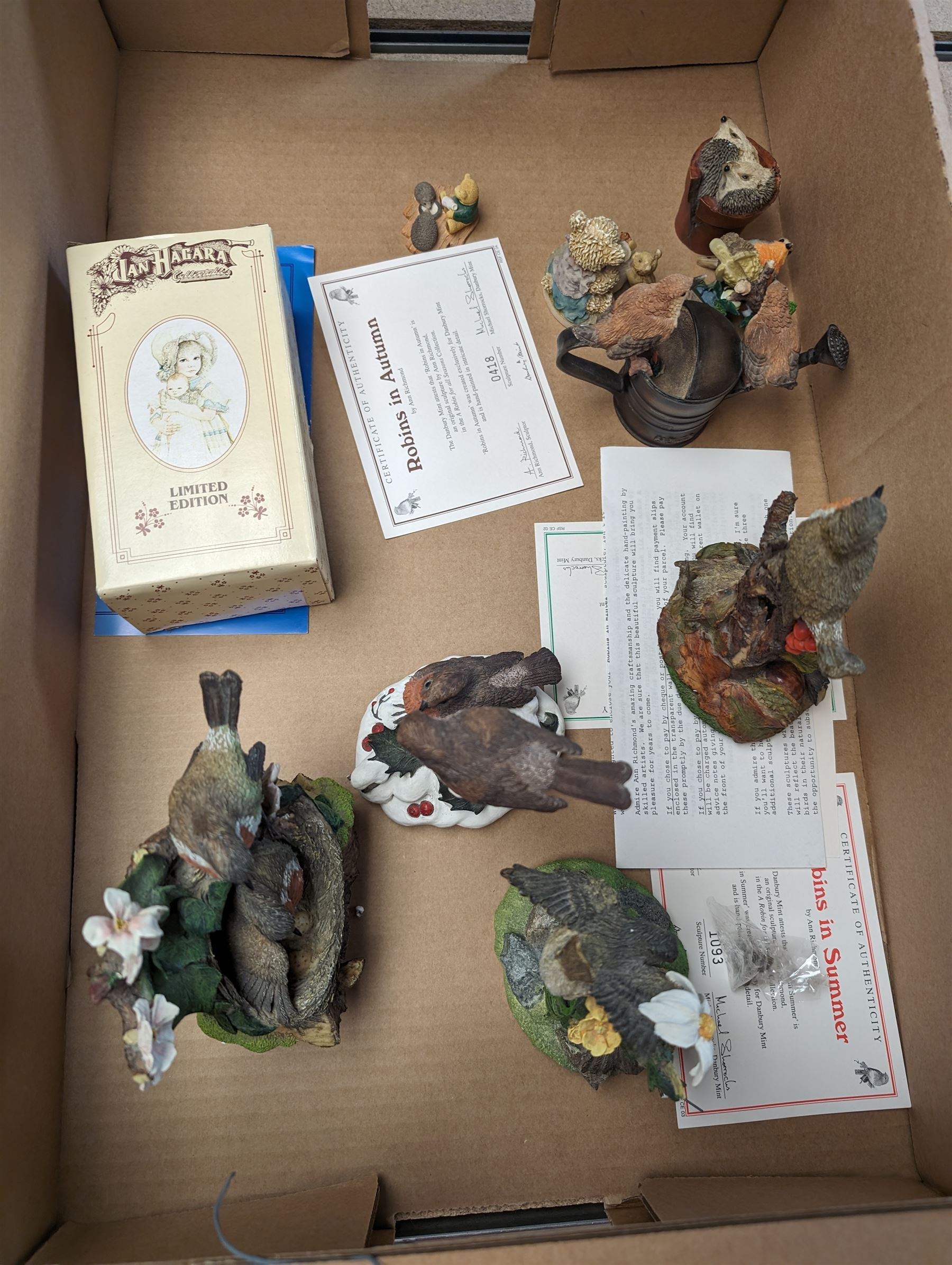 Swarovski crystal figures, together with glass display case, Danbury mint figures etc, in two boxes 