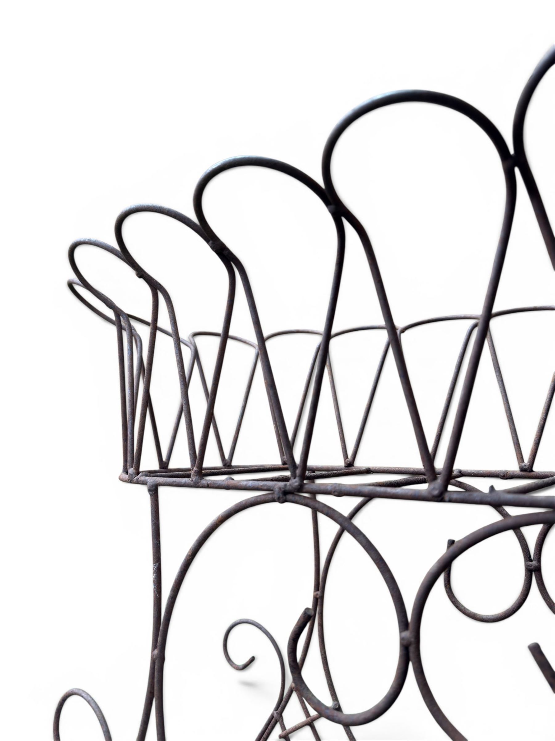 Mid-20th century wirework garden planter, oval form with heart shaped centre, under-tier shelf above scrolling feet