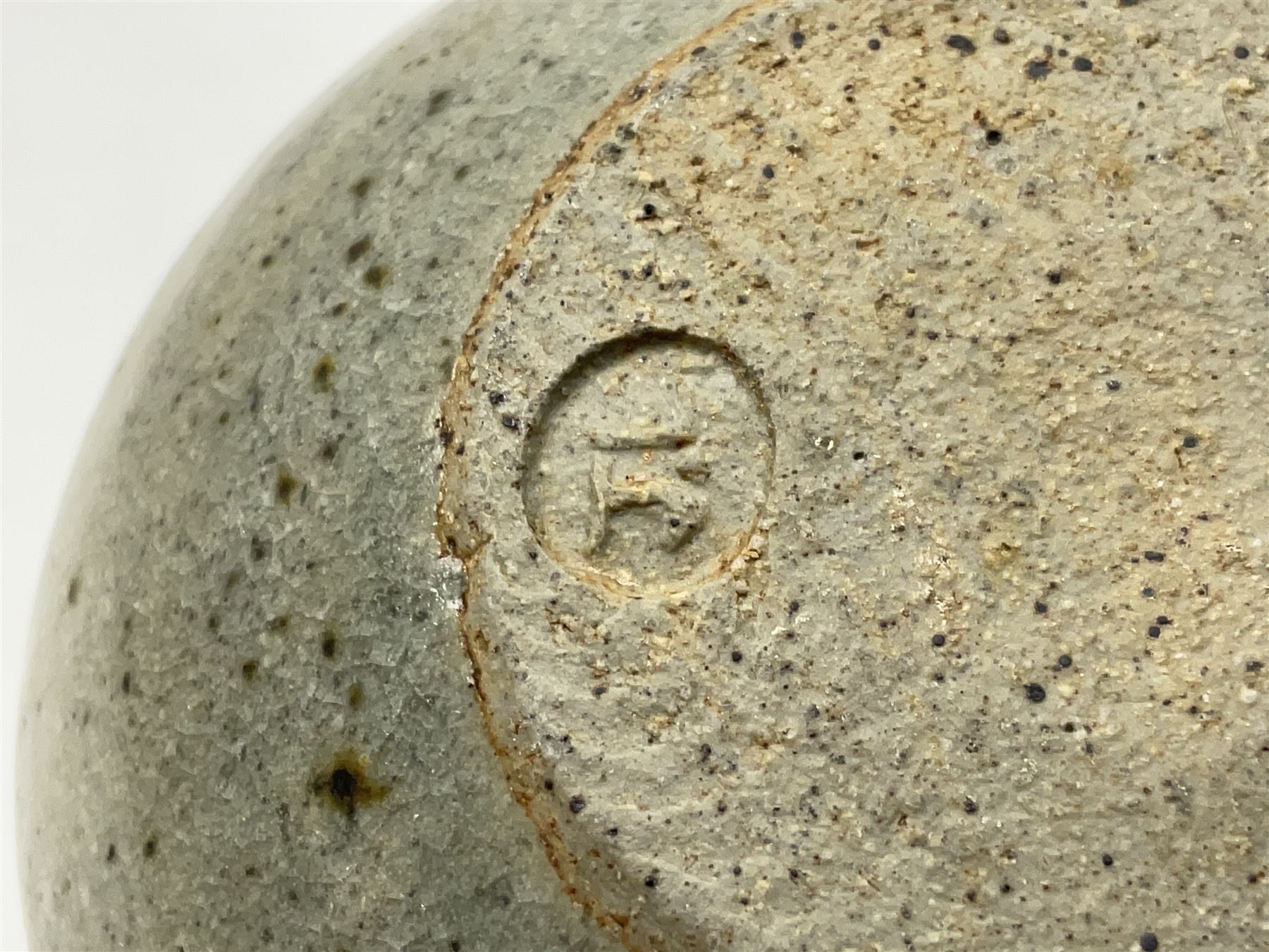 Janet Leach (American, 1918-1997) for Leach Pottery; speckled studio pottery vase of shouldered ovoid form with speckled brown decoration and trailing green and brown glaze upon beige and brown ground, with impressed J.L. monogram and Leach Pottery mark beneath, together with a Jeremy Leach blue speckled lidded circular dish with loop handle, impressed J.L, tallest H11cm