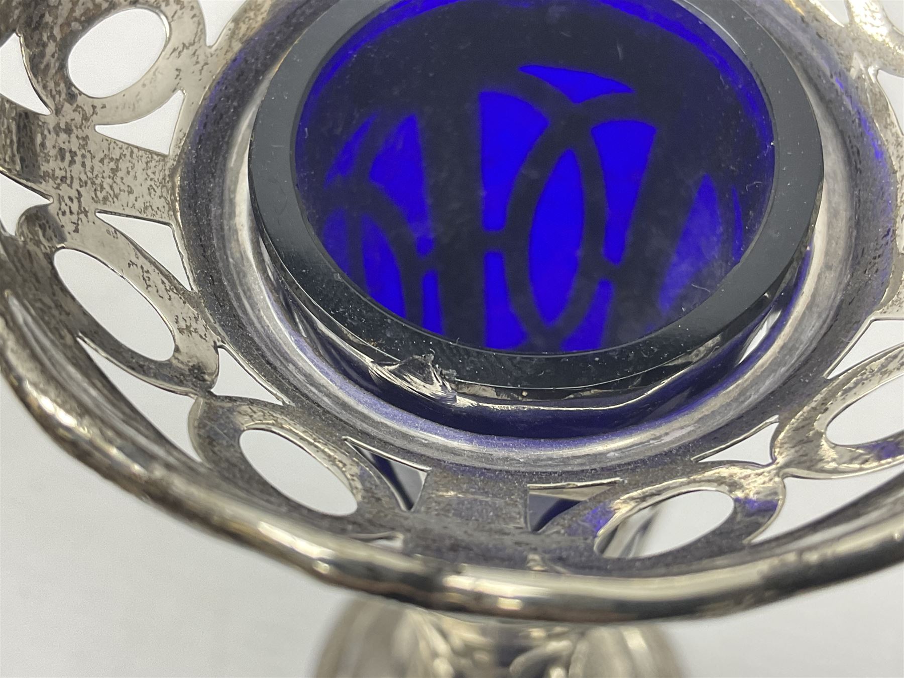 20th century silver specimen vase, of pierced trumpet form with flared rim, filled base, and blue glass liner, hallmarked Birmingham 