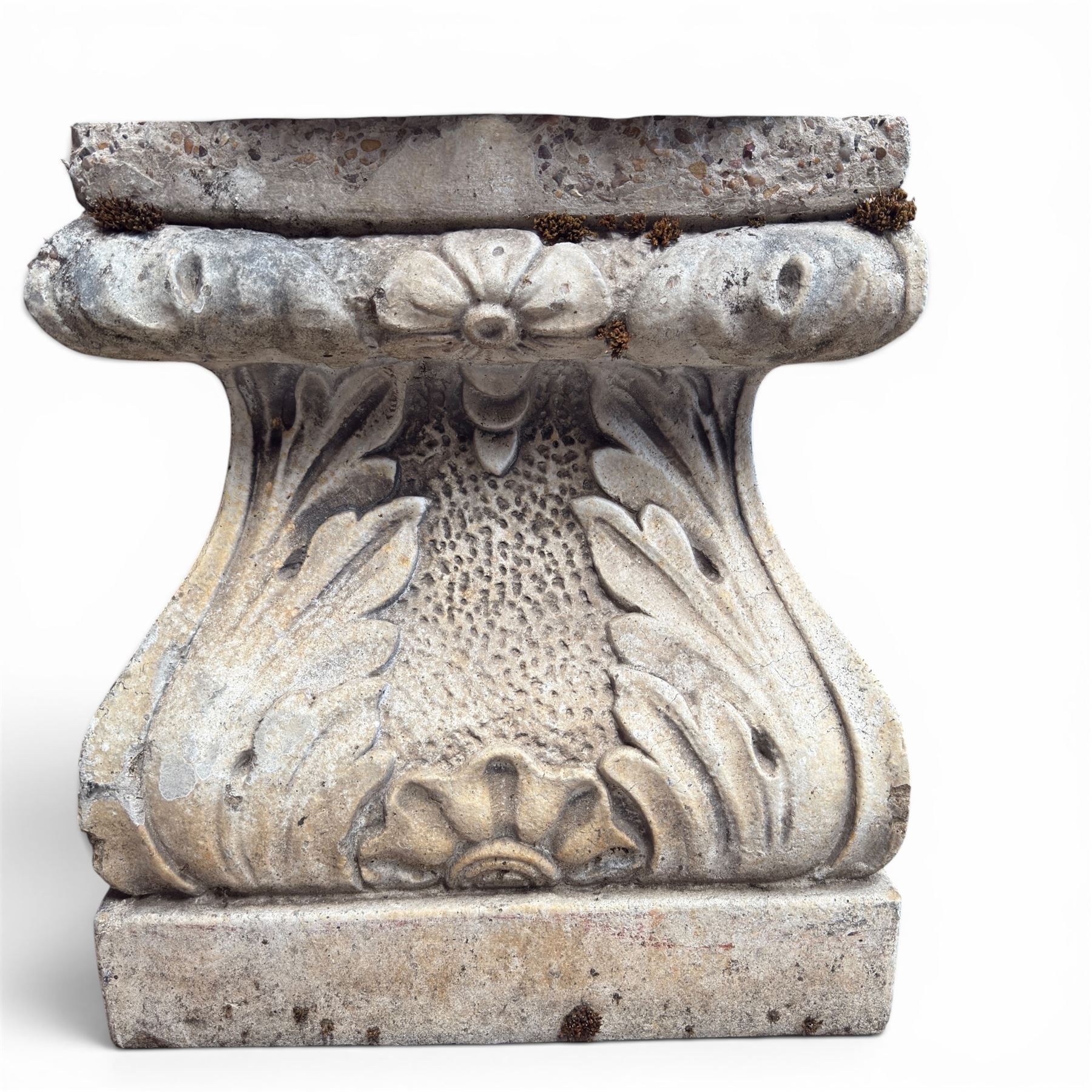 20th century composite stone garden figure, modelled as a kneeling nude female with arms raised behind her head, mounted on an integral cushion, the squared ogee pedestal moulded with acanthus leaves and flower heads, in a white painted and weathered finish