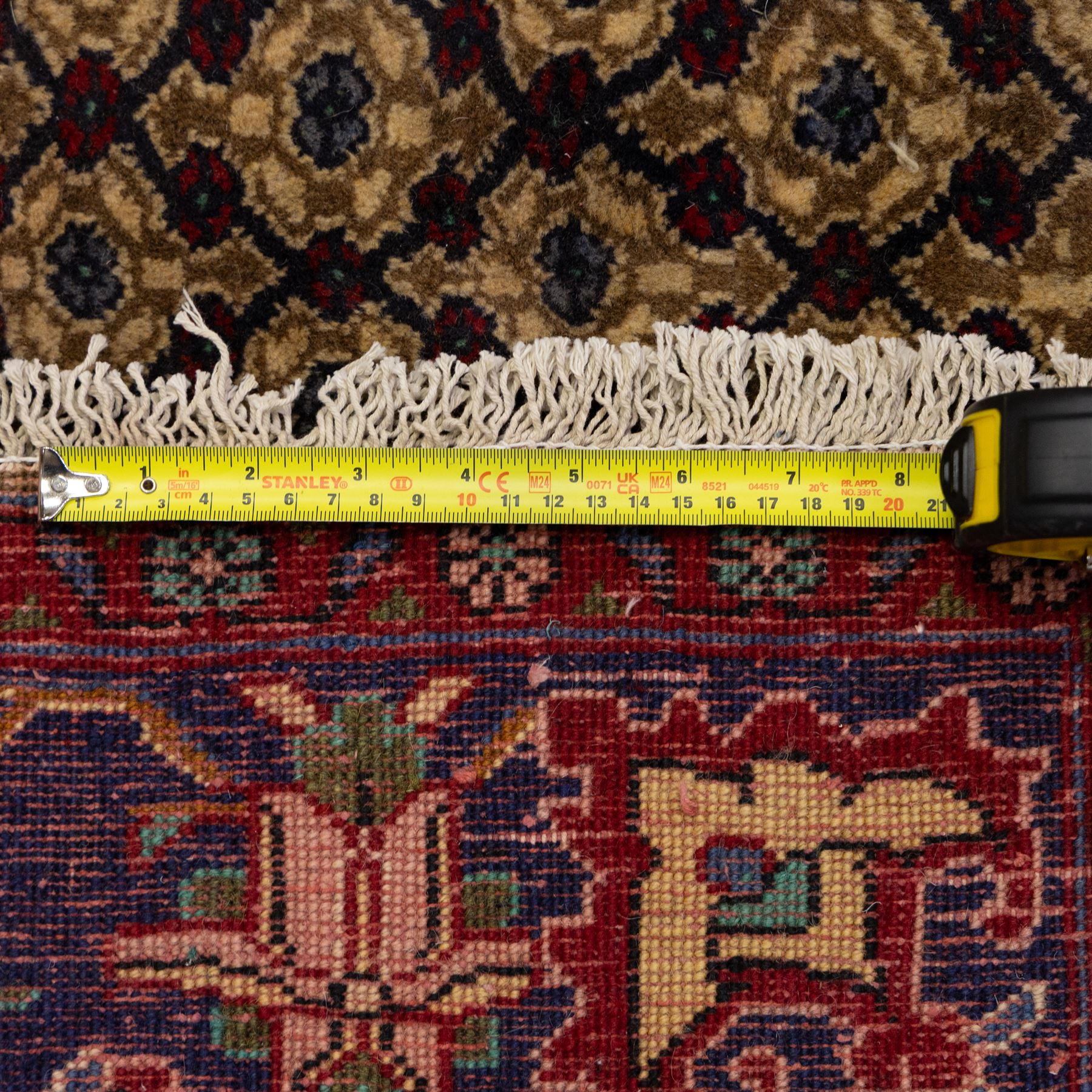 South West Persian Bidjar hand-knotted rug, olive and camel-toned field decorated with an all-over Herati lattice design with a central floral medallion within a wide floral border with shaped floral spandrels and multiple guard borders in tones of navy, ivory, crimson, and green, with cotton fringe ends  