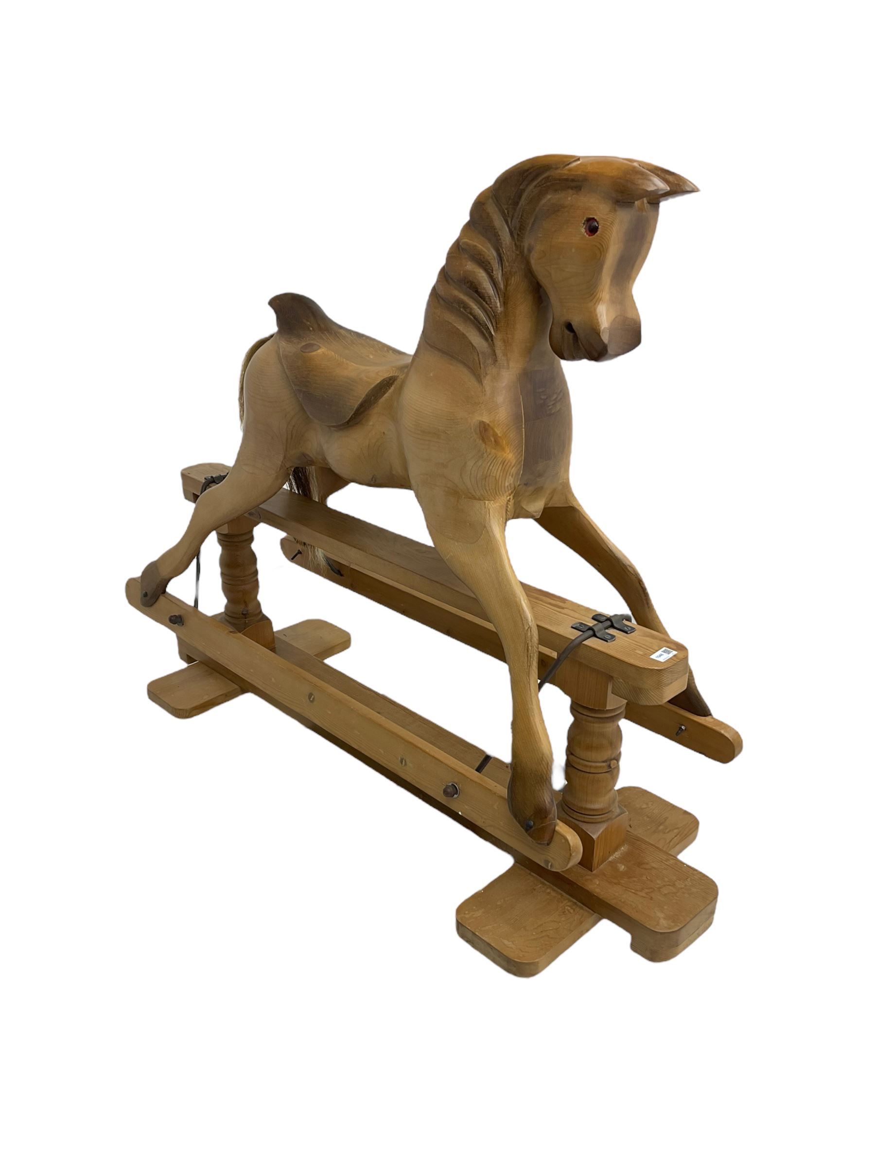 Terry White for White Horses (Hertfordshire 20th century) - Carved pine rocking horse, raised on a pine trestle base