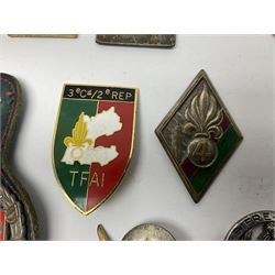 Eleven French Foreign Legion badges including various para, infantry and artillery (some copies)