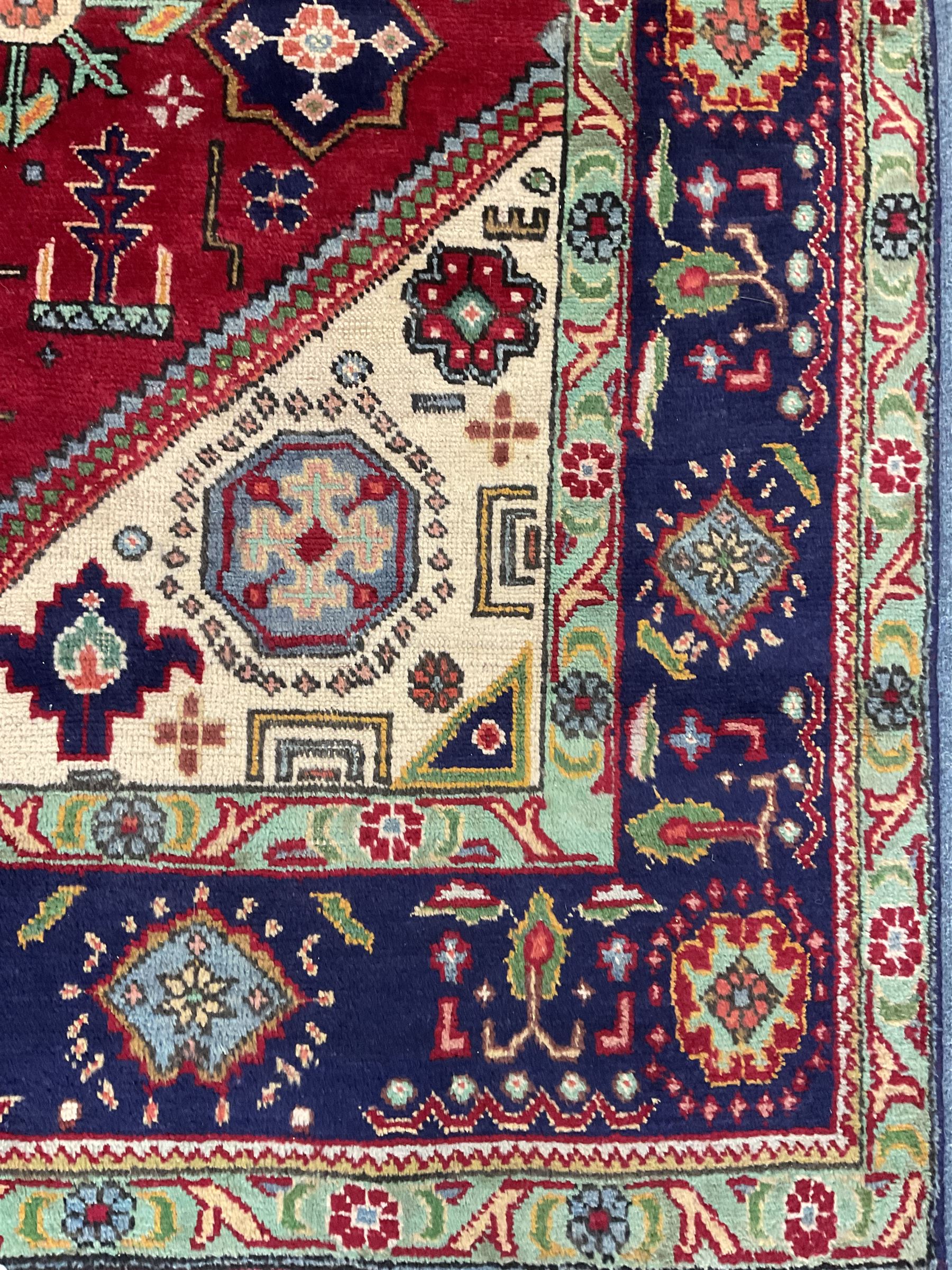 Qashqai red and blue ground rug, with central medallion, green repeating border with geometric motifs 