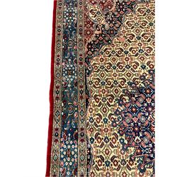 Persian Moud carpet, the field decorated all-over with Herati motifs, central medallion and spandrels decorated with stylised plant and flower head motifs, repeating border with guard