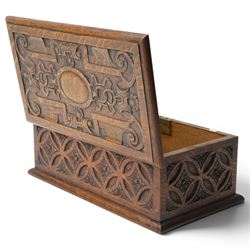 Elizabethan Revival style oak bible box, the central oval boss surrounded with carved strapwork and scrolled decoration, each side with repeating circular motif