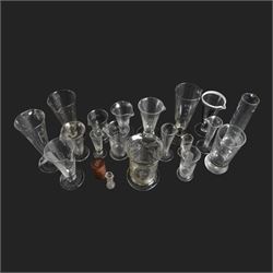 Nineteen apothecary chemists glass measures, of various shapes and age 