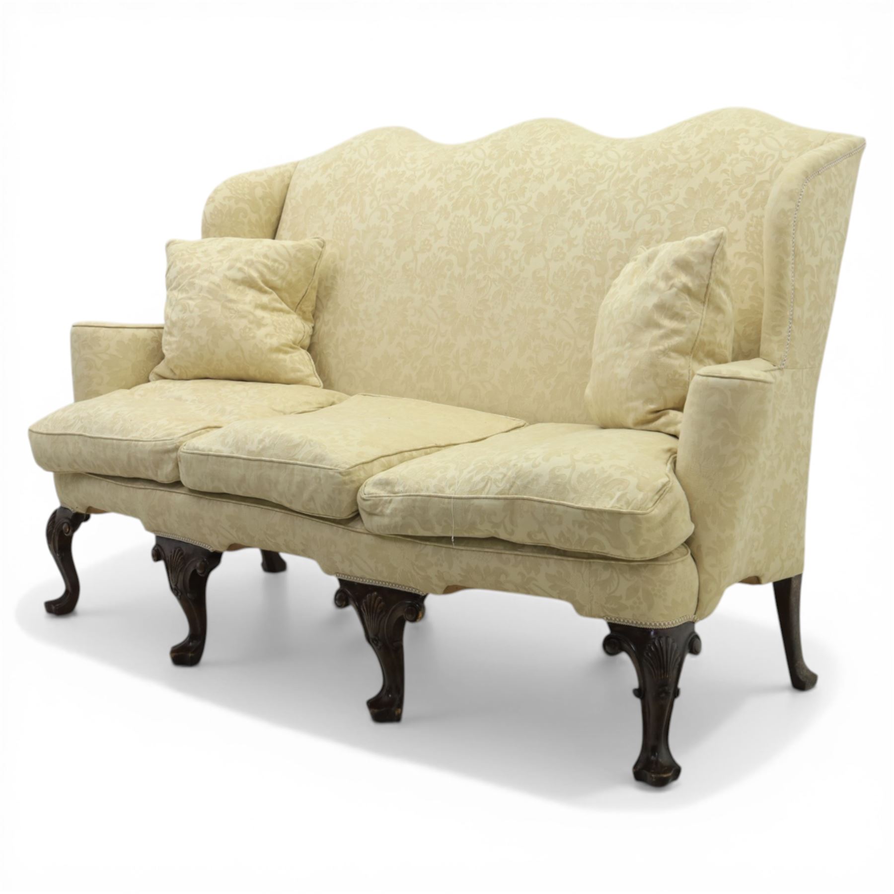 19th century Queen Anne style cream foliate upholstered three seat settee, the shaped and waisted back with serpentine cresting, padded arms over loose seat cushions, raised upon carved cabriole supports with shell carved knees