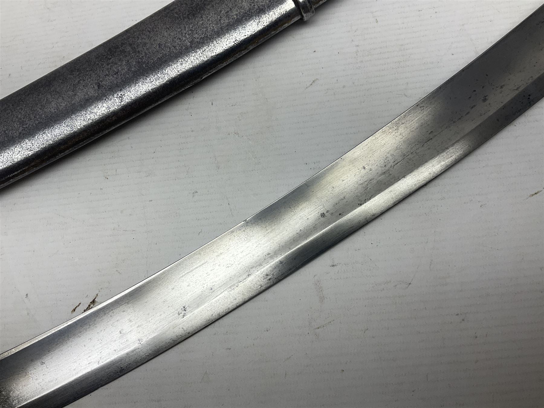 British 1796 Pattern Light Cavalry trooper's sword, the 84cm curving fullered blade stamped Hadley.1 to the back edge, steel hilt with knucklebow, D-shaped langets and leather grip; in polished steel scabbard stamped Osborn & Gunby Birmm. and W.R.16 ( ?16th Light Dragoons) with two suspension rings L100cm overall