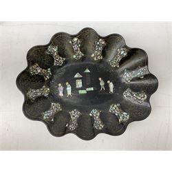  Late 19th / early 20th century Japanese lacquered table top cabinet, heavily decorated with mother of pearl inlay depicting blossoming branches, flowers and birds, the two hinged doors between longer drawers opening to reveal interior fitted with four short drawers, with lift up hinged canted lid, H28cm D9.5cm W23cm, together with mother of pearl inlaid miniature folding screen, dish decorated with walking figures with crimped edge, boxes decorated with flowers, birds and gilt etc