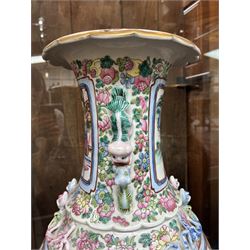 Large pair of 19th century Cantonese famille rose vases, each painted with various courtly scenes, including a display of warriors fighting on horseback before an official and his attendants, double Buddhist lion handles and applied at the shoulders with chilong, the lower band painted with Greek key motif, H58cm (2)