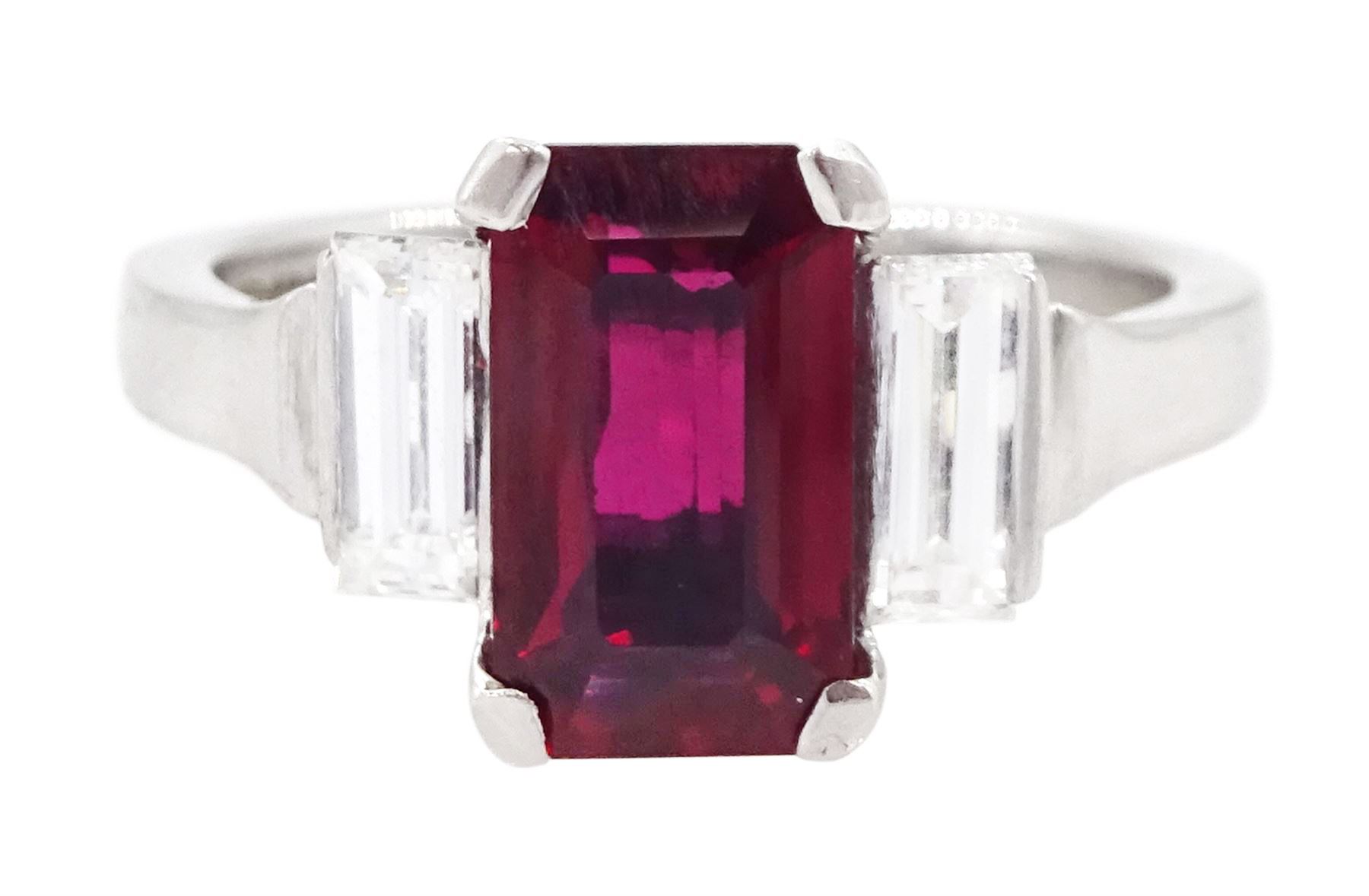 18ct white gold ruby and diamond three stone ring, single emerald cut Thai ruby of approx 2.00 carat, with a baguette cut diamond set either side, hallmarked, total diamond weight approx 0.60 carat