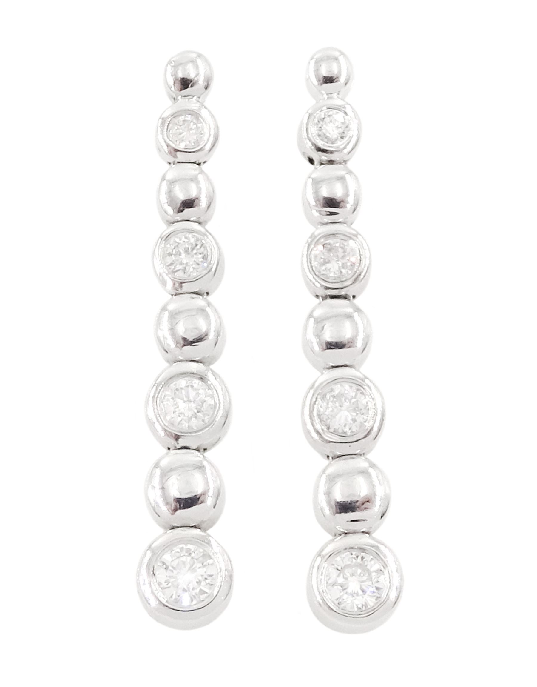 Pair of 18ct white gold round brilliant cut diamond stud earrings, Sheffield 2002, total diamond weight approx 0.25 carat