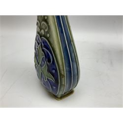 Two Royal Doulton stoneware vases, the first example with tubelined floral decoration, the second with Art Nouveau decoration, together Doulton Lambeth vase of flattened form with foliate decoration on a green ground, all with impressed mark beneath, tallest example H26cm