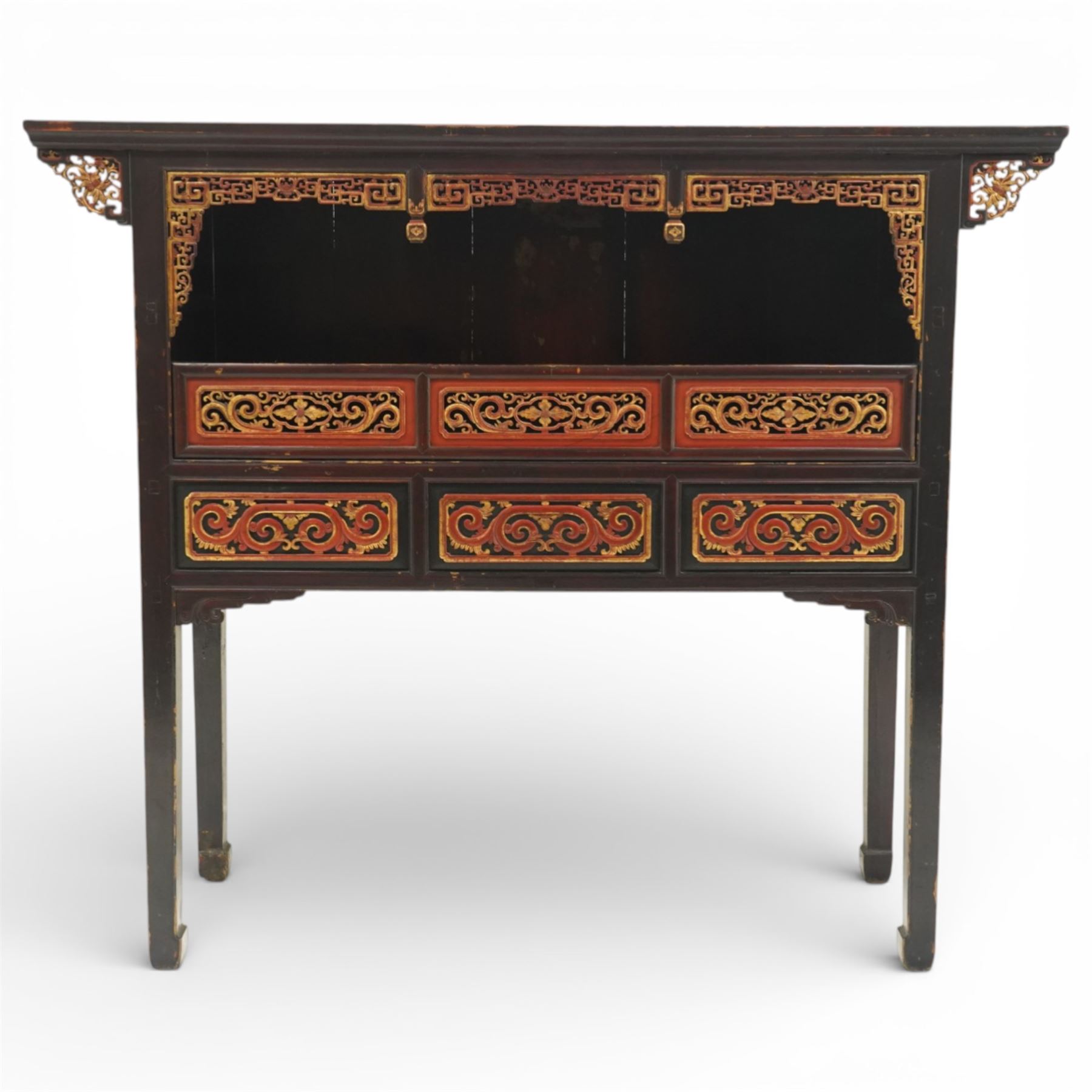 Chinese black lacquer Buddha cabinet, moulded top over open display recess framed by pierced geometric fretwork and corner spandrels, the base fitted with an arrangement of five drawers with carved and gilt scrollwork panels, on square supports with shaped apron brackets