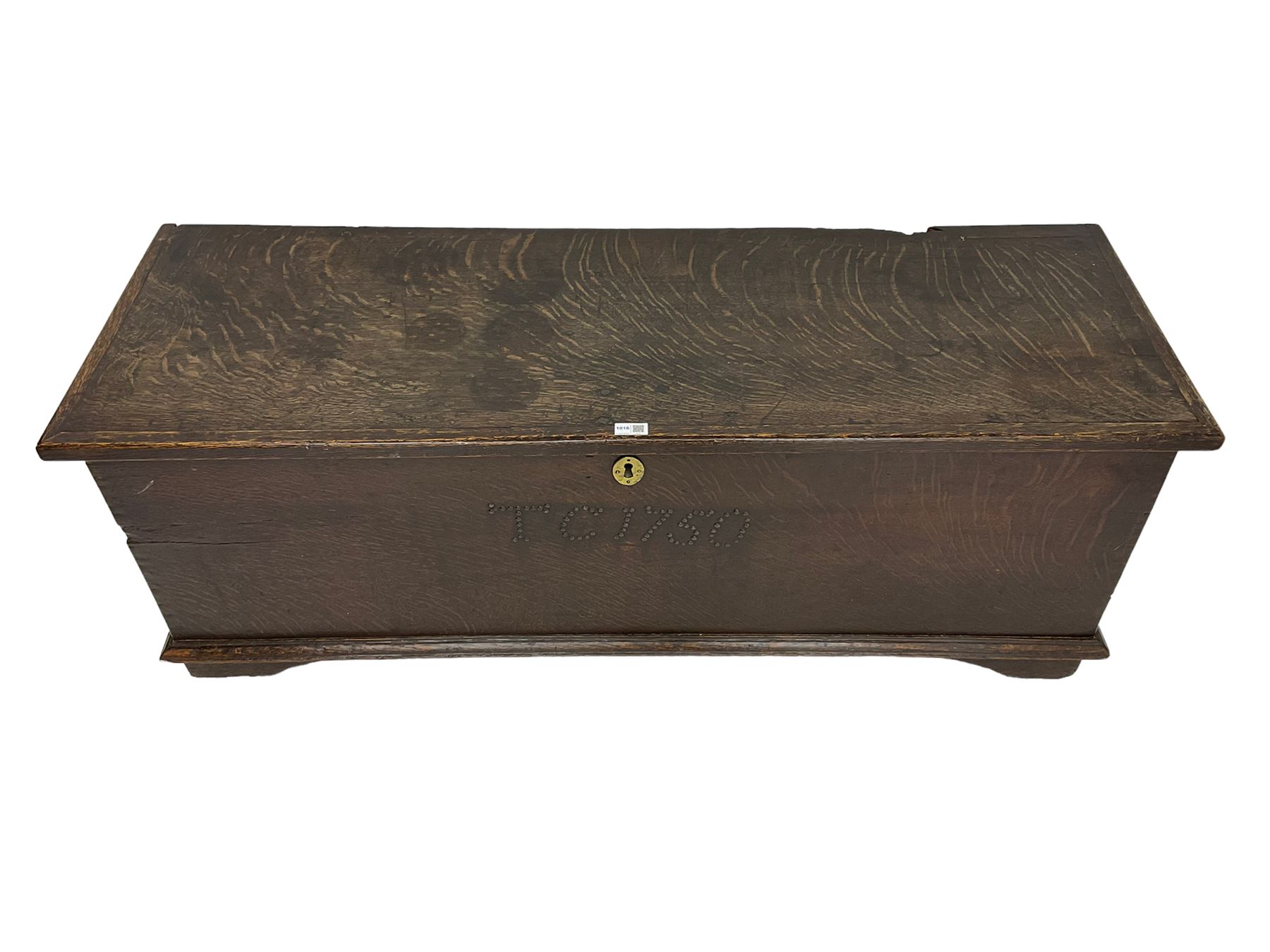 18th century oak sword chest or coffer, hinged lid with moulded edge and iron fittings concealing candle box and main compartment, the front with studwork spelling 'TC 1750', raised on bracket feet
