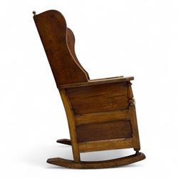 19th-century beech, yew, elm, and mahogany wingback vernacular rocking chair, high back with shaped wings, scroll arms with turned supports, lift-up seat,  square legs on ring turned supports on curved runners 