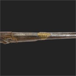 Middle Eastern percussion cap rifle, the 107cm  barrel with four brass bands and ramrod under, overall L143cm, together with another percussion rifle the 106cm barrel a copy of a 17th century Spanish barrel, complete with fake stamp, by vendors repute this rifle was confiscated from tribesmen in Kurdistan by police
Sold as an exempt item under Section 58 (2) of the 1968 Firearms Act, to be held as a curiosity or ornament