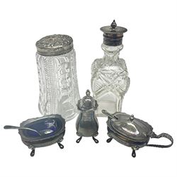Modern silver five piece cruet set, comprising mustard pot and cover, pepper, open salt, each with shaped rims and upon four pad feet, and two matching condiment spoons, all hallmarked David Hollander & Son, Birmingham 1977, together with a cut glass sugar caster with silver lid, hallmarked and a cut glass salt shaker with EPNS lid