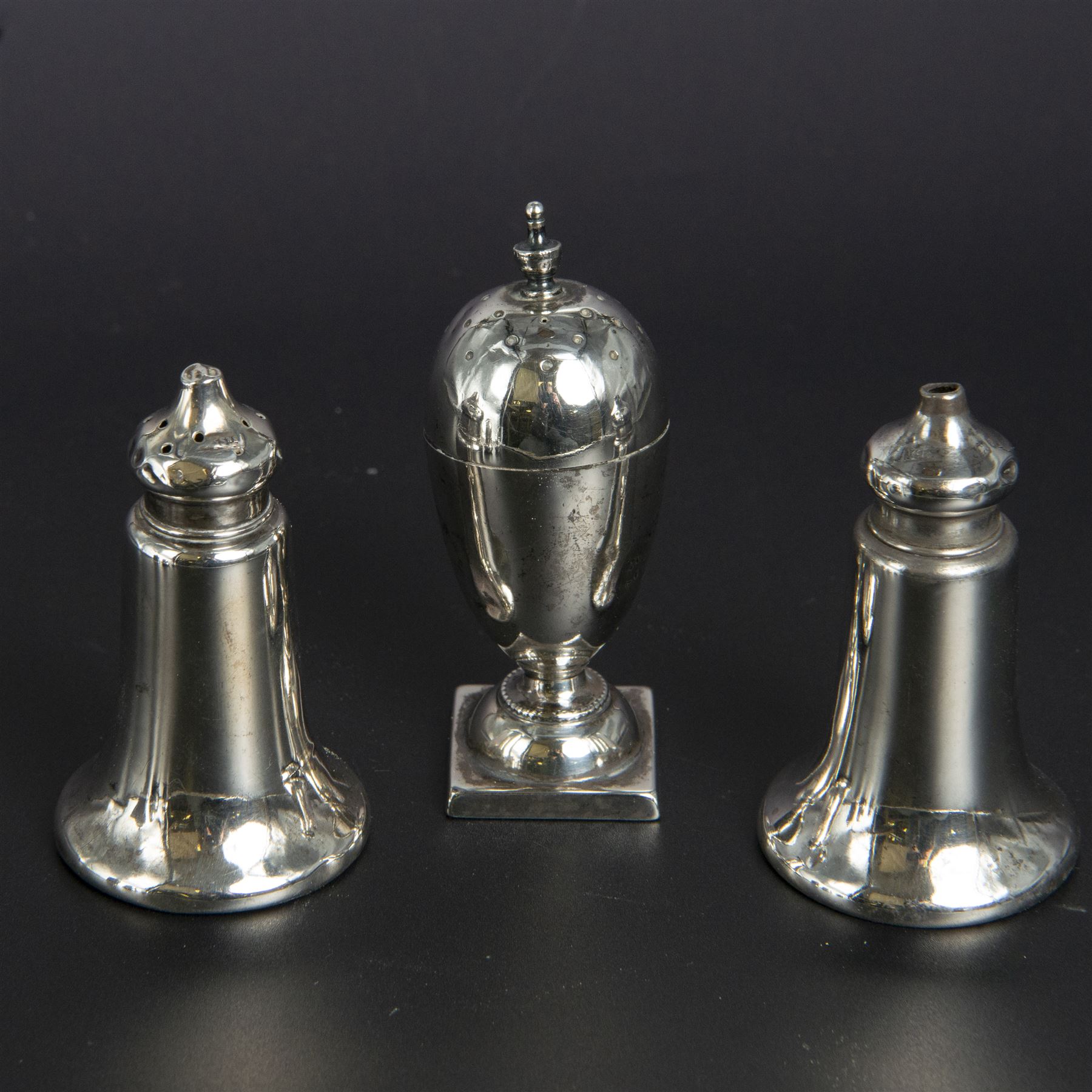 Group of silver cruets, including a pair of Edwardian conical shaped salt and pepper shakers and four other salt/pepper shakers, all hallmarked 