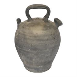Four 20th century Spanish blackened earthenware botijo or cruche vessels, each of typical baluster form with central loop handle and opposing spout, impressed marks to handles, tallest example H31cm