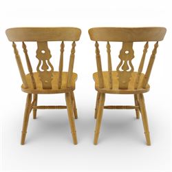 Solid oak dining table and set of seven pine farmhouse chairs including two carvers, rectangular top with tongue and groove style finish, supported a 'H' stretcher with square chamfered legs, pine farmhouse chairs with central splat and turned legs