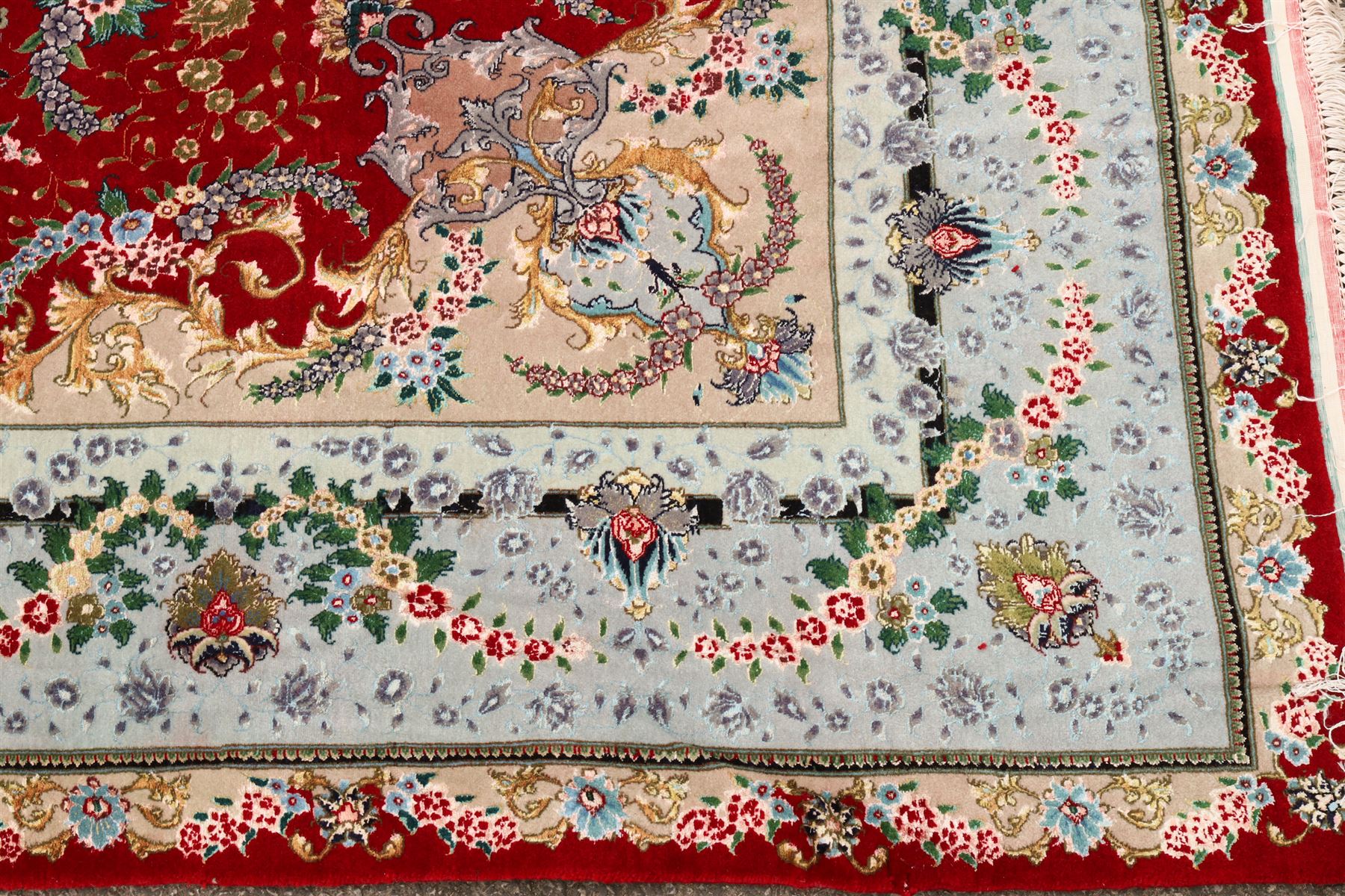 Fine Persian silk inlaid crimson ground Tabriz rug, the shaped field decorated with a central foliate pole medallion filled and surrounded by finely knotted floral motifs and trailing foliage, the cyan guard stripe with bold festoons and palmette motifs