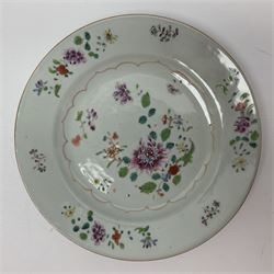 Three 18th century Chinese Famille Rose plates, the first example enamelled with blossoming peonies, rockwork and fence, the other two examples of similar design, decorated with blossoming peonies and sprigs within shaped inner borders, each approximately D23cm