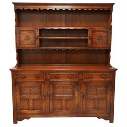 20th century oak dresser, moulded cornice above open plate rack with shaped frieze, flanke...
