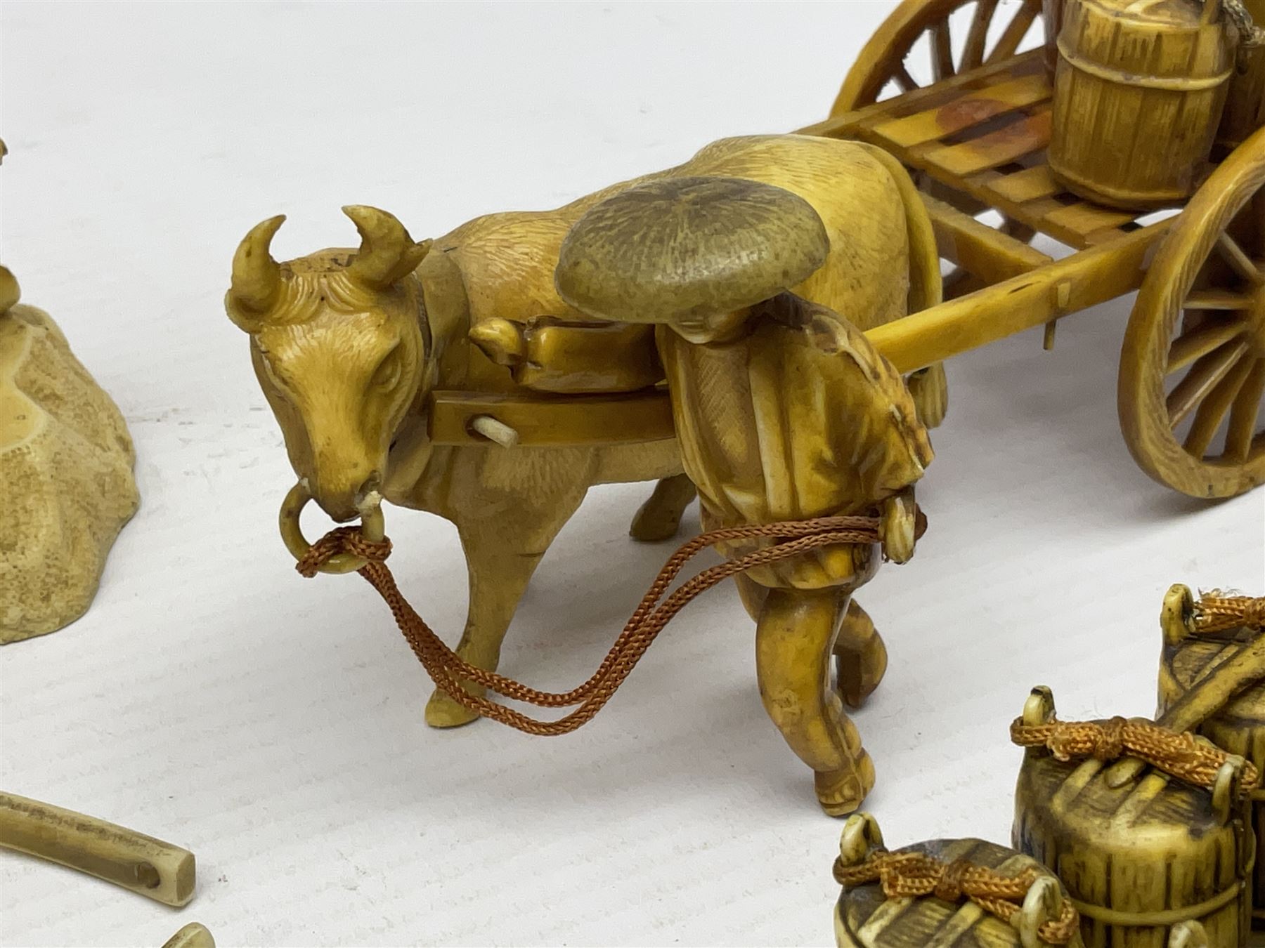 Collection of Japanese celluloid figures, including Rickshaw groups, fishing scene, oxen etc 