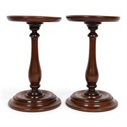 Pair of 19th century turned mahogany candle stands, each with circular top upon a baluster...