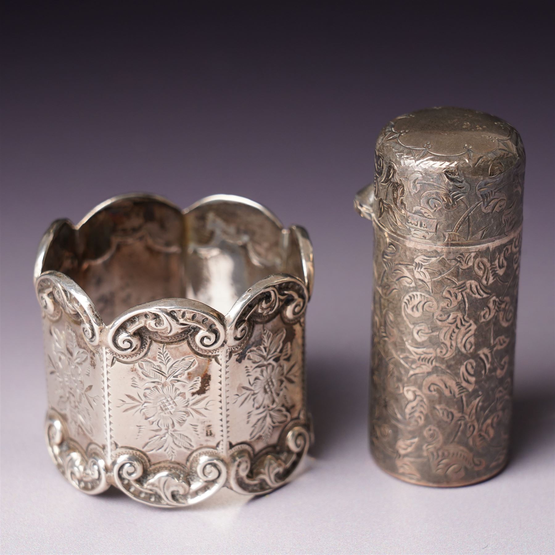 Small glass scent bottle with silver and red enamel cover, Edwardian silver cased scent flask with engraved decoration, heptagonal silver napkin ring, pair of small silver barrel shape salts, glass pepperette with silver and mother of pearl cover, small silver stone set fork by William Robb and a silver salt spoon