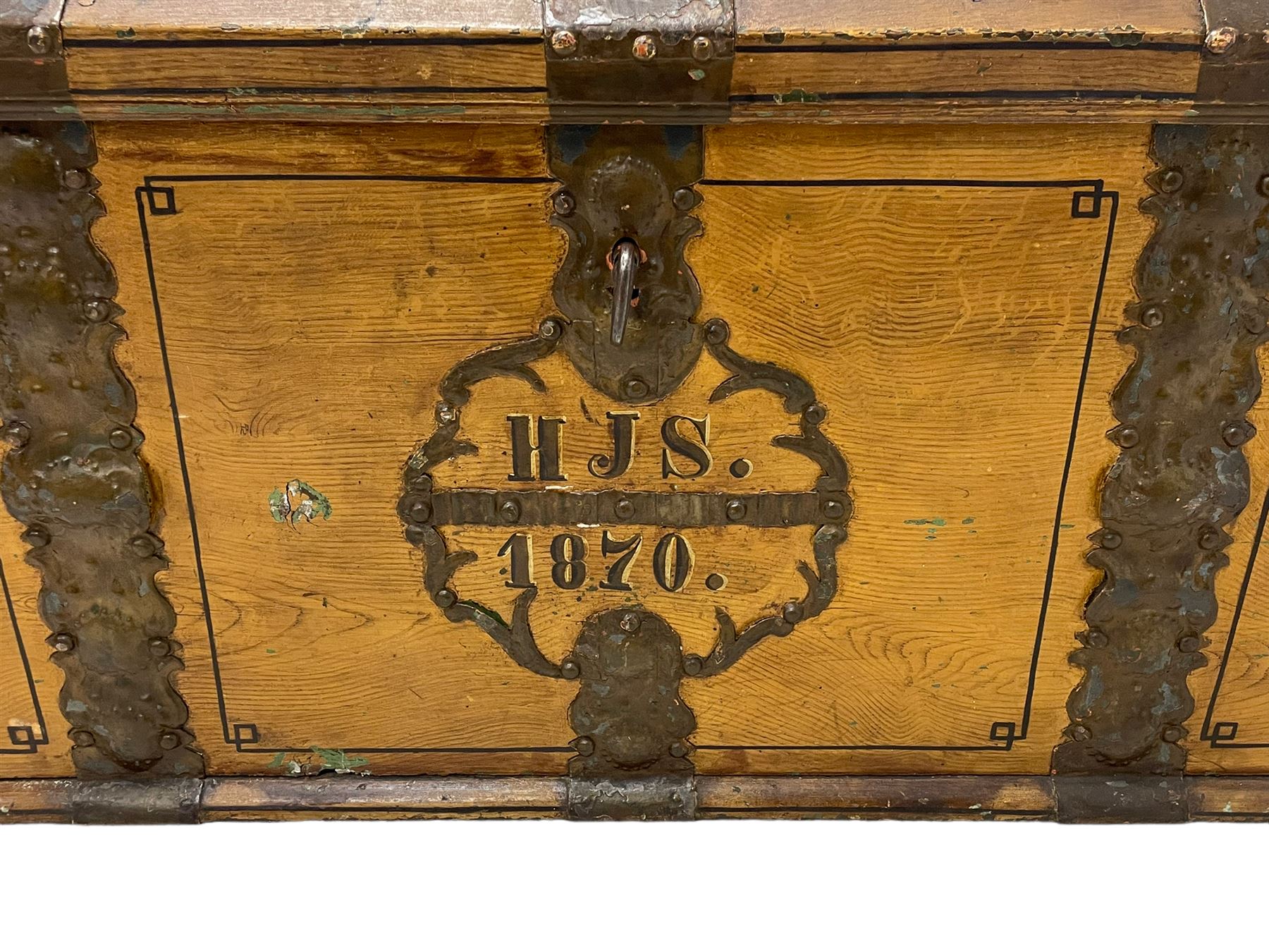 19th century painted oak sea chest, hinged dome top enclosing small compartment, bound by shaped and pressed metal strapwork, scumbled finish to resemble oak and painted with small vignettes depicting portraits and landscapes within panels, fitted with large wrought metal carrying handles, the front inscribed 'H.J.S. 1870' 