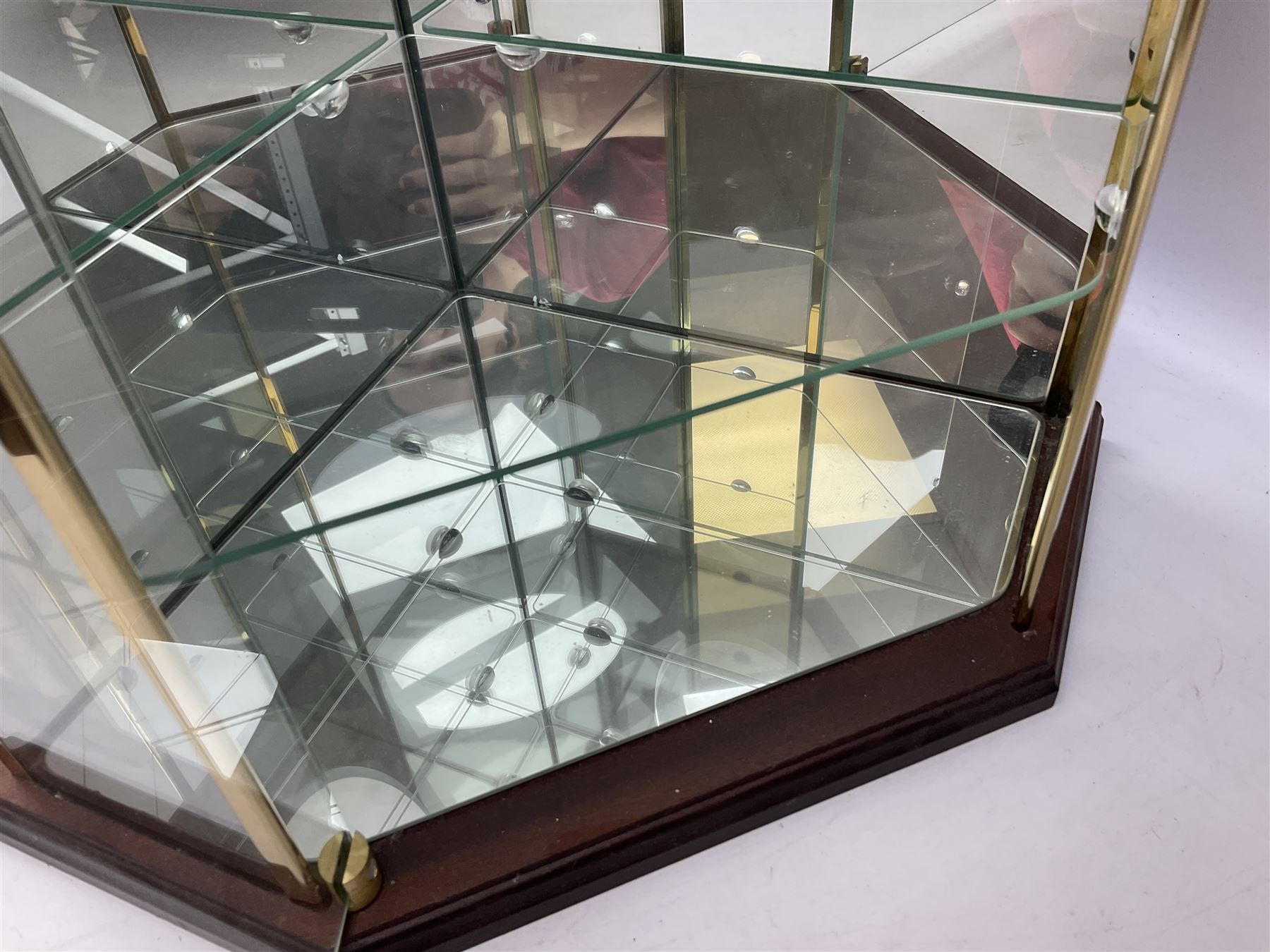 Swarovski Crystal Masquerade trilogy; 1999 Masquerade Pierrot, 2000 Columbine, 2001 Harlequin all with accompanying plaque, stand and original box, together with a glass display case with mirrored back and sides 