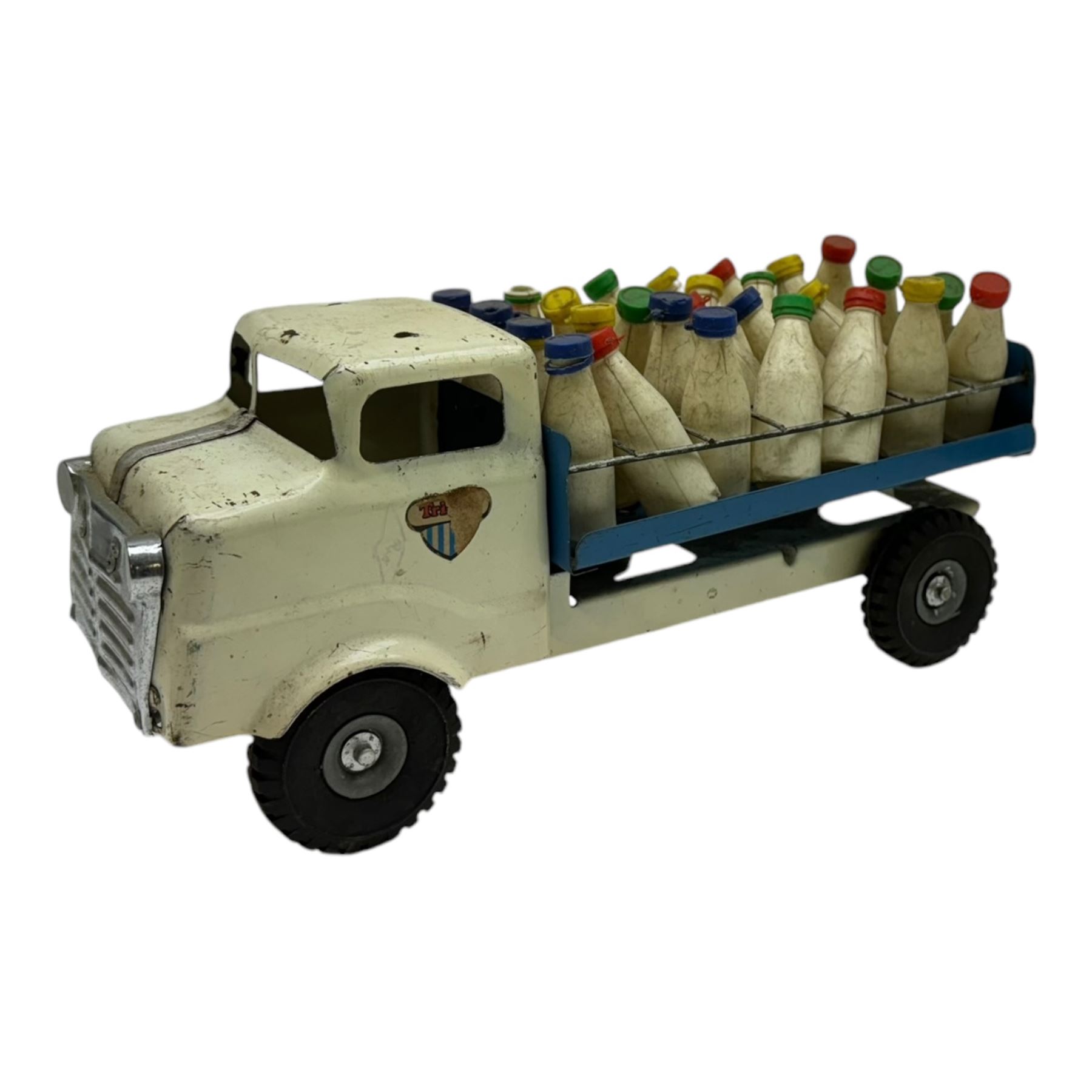 1950s Triang pressed steel milk float, containing twenty eight plastic milk bottles with coloured tops, together with a 1950s Triang pressed steel locomotive 'Triang Express', tallest H21cm