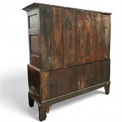 18th century oak dwarf press cupboard, the upper section with twin arched panel doors above three short and two long drawers, each with brass plate handles, shaped apron and stile feet, of compact country form