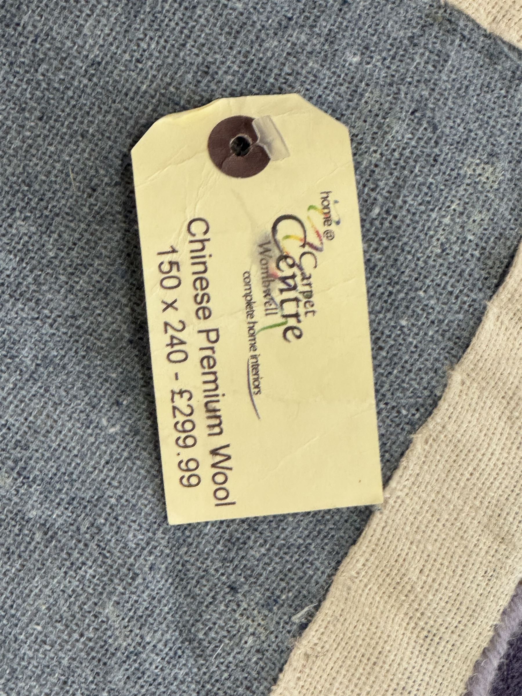 Chinese wool rug, purple ground with tonal floral and foliate pattern, central medallion of stylised flowers, the corners with large rosettes, framed by broad border of scrolling floral and leafy motifs 