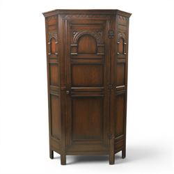 20th century dark stained oak hall robe, cantered sides enclosing a hooks and a shelf, pan...